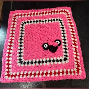 This is a handmade crocheted Minnie Mouse granny square blanket.
